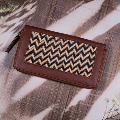 Brown wallet with a zigzag pattern on a textured surface